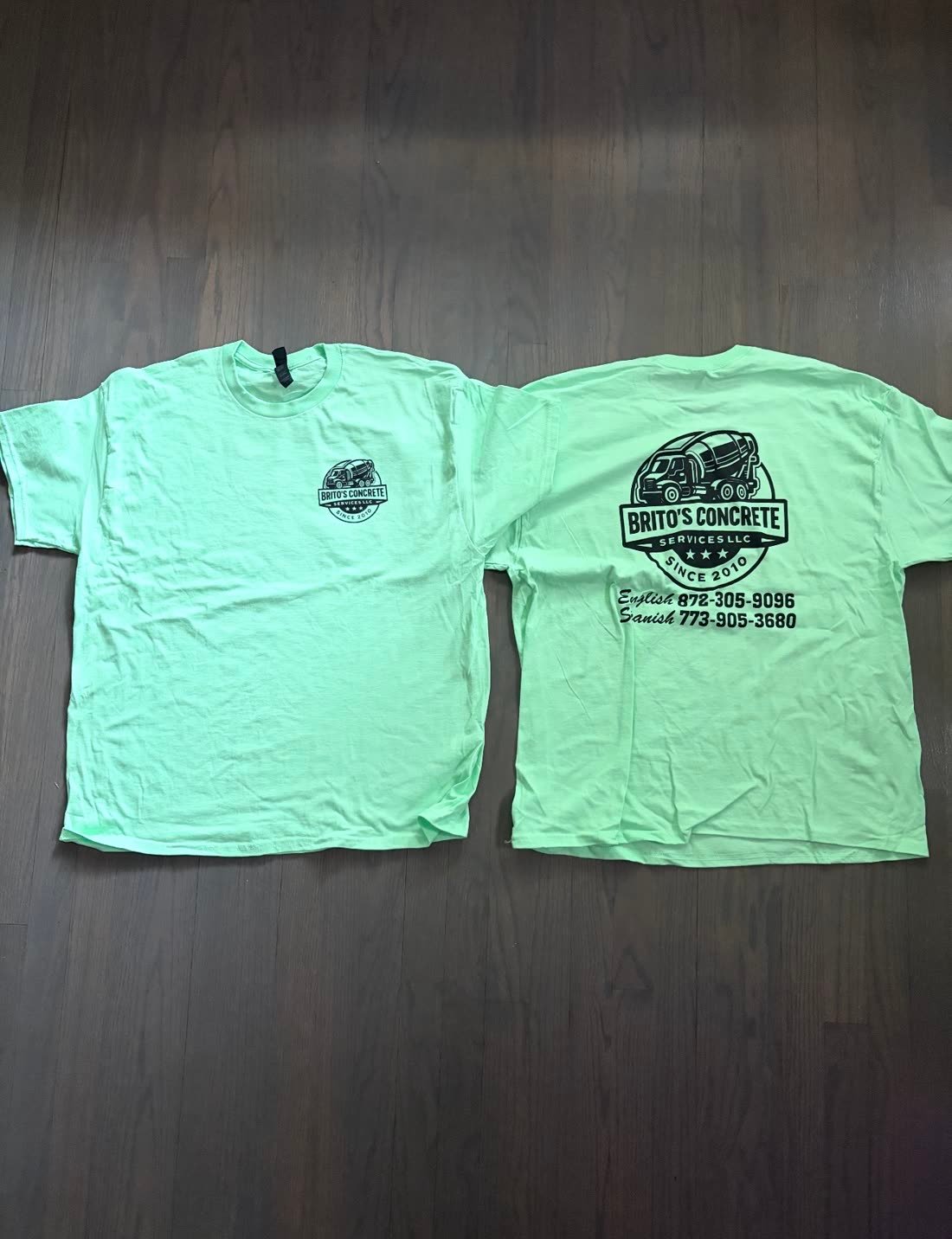 Mint green crew shirts with a concrete company logo, front and back