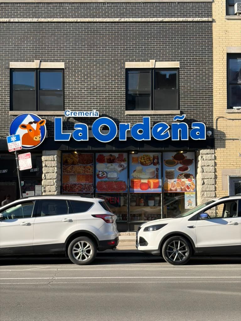 Printed food photo displays covering a storefront window