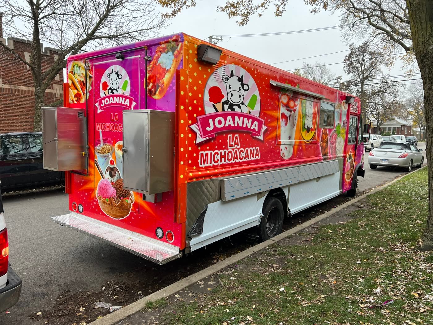 Full wrap on a pink and orange ice cream food truck